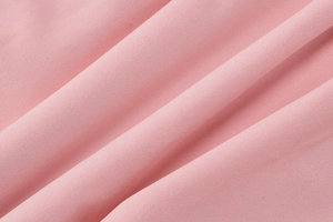 Close-up of pink fabric texture and ruffled hem details on summer mini dress