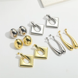 Polished oval, square, and water drop gold and silver earrings set on white background