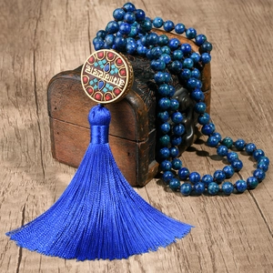 Dettaglio della collana tibetana con perline blu e ciondolo artigianale con nappa blu