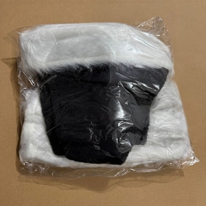 Folded black and white plush Christmas hat packaged in a transparent plastic bag
