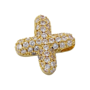 Macro detail of gold-plated plus sign pendant with pave-set cubic zirconia stones