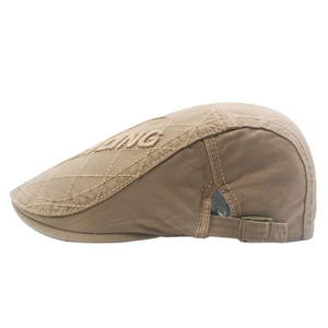 Khaki cotton newsboy cap with diamond quilting and side metal buckle in profile view