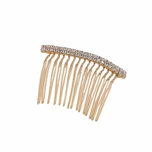 Detailed macro view of a golden hair comb with two rows of sparkling white rhinestones