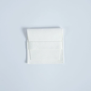 Detailed view of a white microfiber suede jewelry pouch with square flap and neat stitching