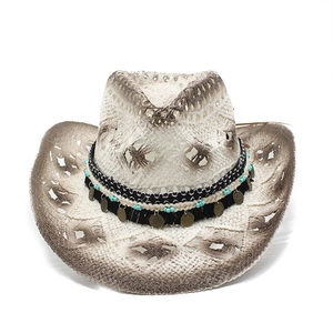 Close-up of bohemian hollow straw cowboy hat with turquoise beads and metal coin decor