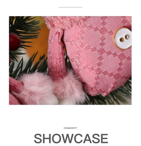 Macro detail of pink waffle fabric and faux fur texture on a Christmas plush ornament