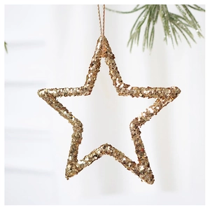 Detailed close-up of champagne gold glitter star Christmas tree ornament with pine needles
