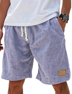Detail of light blue linen shorts featuring a cream drawstring and side pocket texture