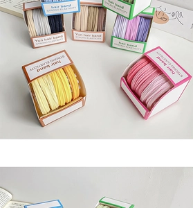 Detail view of colorful high-elastic hair bands in organized storage boxes