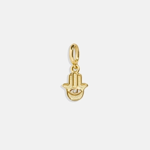 Golden Hamsa hand pendant with matte texture and sparkling center stone on white background