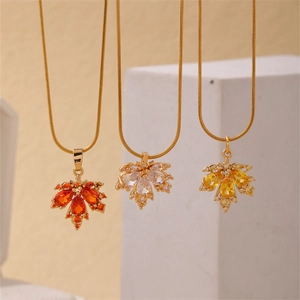 Elegant gold maple leaf pendant necklace with orange, white and yellow gemstones