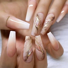 Detailed view of nude gradient coffin press-on nails with marble texture and gold foil flakes