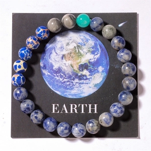 Detail of natural solar system stone beads with earth theme display card and tiger eye gems
