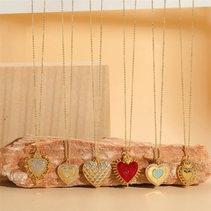 Collection of six gold heart pendant necklaces with crystals and enamel on natural stones
