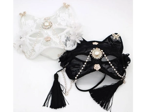 Detail of lace cat mask featuring pearl chains, rhinestones and flowing tassels