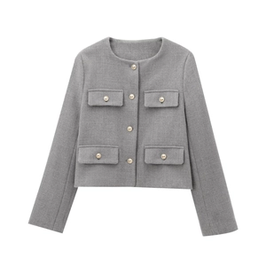 Detail of grey cropped jacket showing textured woven fabric and gold button closures