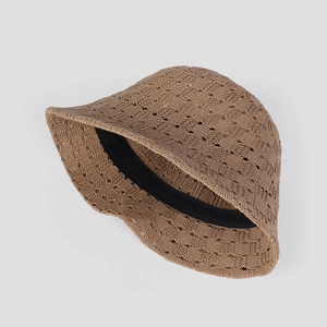 Detail of brown breathable crochet knit sun hat featuring hollow texture and soft inner band