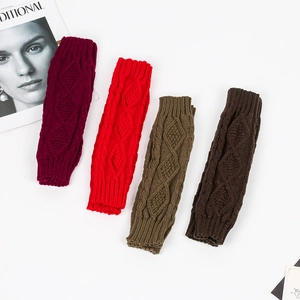 Close-up of cable knit texture and ribbed cuffs on long fingerless arm warmers