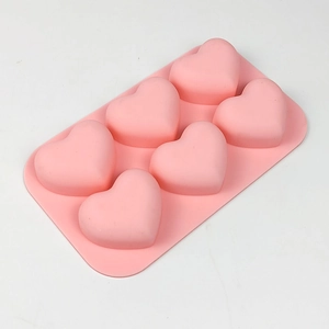 Macro view of pink silicone mold with six heart cavities for DIY baking and chocolates