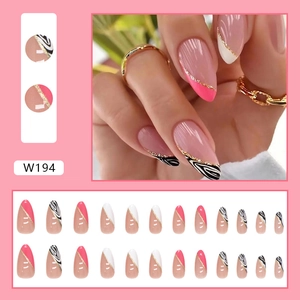 Almond shaped press-on nails with pink French tips and golden glitter ribbon accents