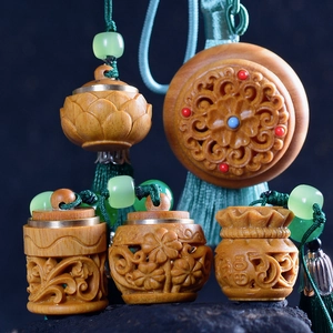Close-up of wood carved lotus and gourd pendants with green tassels and beads