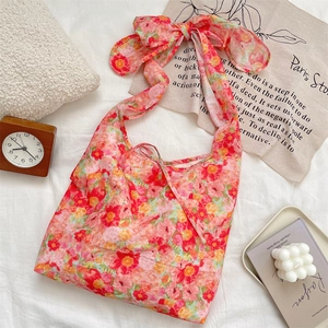 Detailed view of the fabric floral tote bag with a stylish bow-tie shoulder strap design