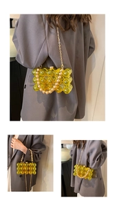 Detail view of yellow acrylic bubble texture evening bag with pearl handle and gold chain