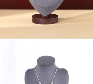 Detailed view of silver crystal necklace and earrings on walnut portrait display stand