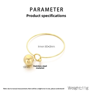 Detailed view of 18mm polished gold hollow sphere pendant on a 60mm stainless steel bangle