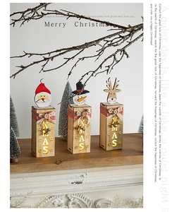 Detail of wooden Christmas LED house set with Santa and reindeer on a cozy mantle