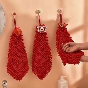 Detail of red chenille hand towel with lion dance embroidery and hanging loop