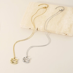 Detailed close-up of gold and silver rocking horse pendants with sparkling rhinestones