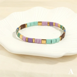 Detail of bohemian Tila bead bracelet with purple and mint green square glass beads