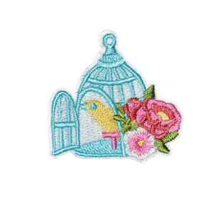 Floral embroidery patch featuring a yellow bird in a light blue cage with pink flowers