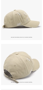 Close-up of distressed beige baseball cap with white embroidery and metal adjustment buckle