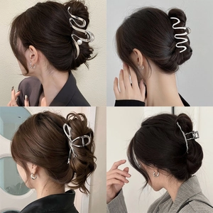 Silver metal shark hair clips in butterfly and wave shapes shown on model