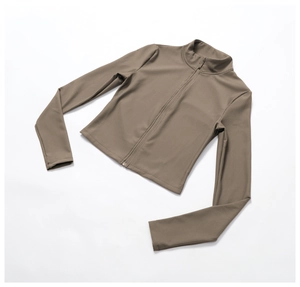 Detail of ribbed khaki yoga jacket showing slim fit cut and vertical texture