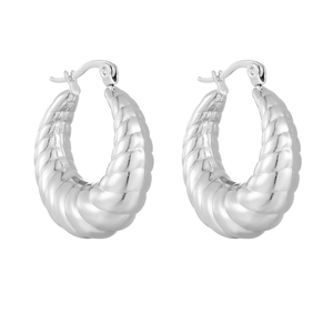 Detailed close-up of silver twisted rope hoop earrings with a bright metallic finish