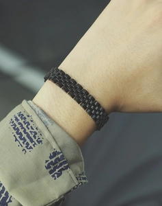 Close-up of a sleek black link chain bracelet for men with a polished reflective finish