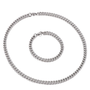 Men's 7mm silver stainless steel curb chain necklace and bracelet set on white background