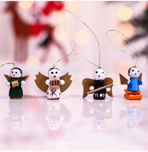 Detailed view of four handcrafted wooden angel ornaments with musical instruments