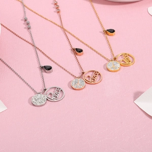 Three-color peace sign pendants in silver, gold, and rose gold with pavé crystals