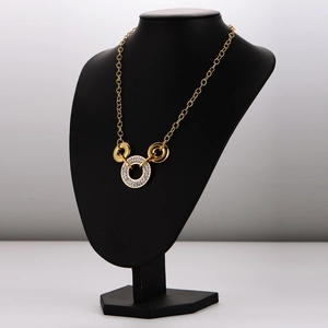 Gold stainless steel interlocking ring necklace with sparkling crystals on black mannequin