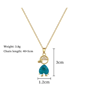 Detail of gold titanium necklace featuring a blue heart gemstone and diamond pendant