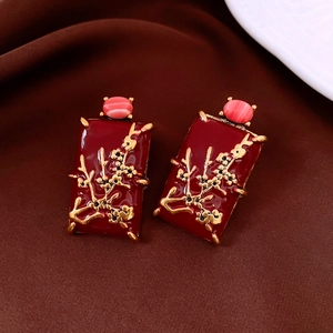 Detail view of vintage red enamel rectangular earrings with gold plum blossom relief
