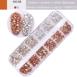 Detail view of 12-grid nail art box with 1440 amber and white flatback glass rhinestones