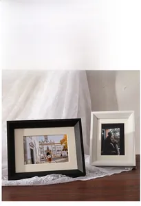 Detail view of thickened black and white wooden photo frames with inner mat boards