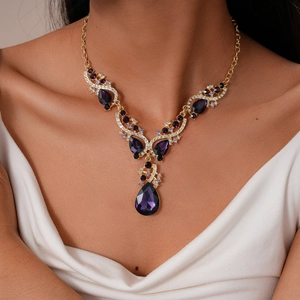 Detail of luxury necklace with purple teardrop gemstones and small diamonds