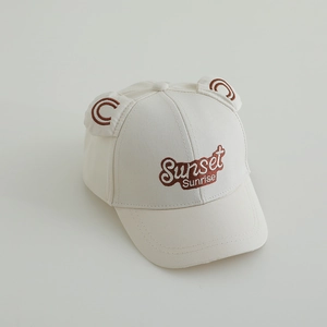 Close-up of beige cotton baby cap with Sunset Sunrise embroidery and cute 3D bear ears