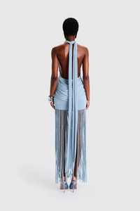 Back view of light blue halter backless dress featuring long fringe detail and slim fit